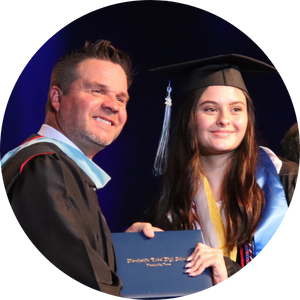 teen girl and principal dressed up for graduation